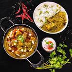 Palak paneer in a kadhai with cumin rice and onion raita