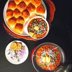 Pav bhaji with buttered pav, chopped onion and lemon